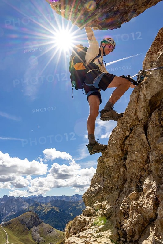 Mountaineer climbs on Ferrata Furcela de Saslonch, Langkofelscharte via ferrata, Dolomites, Trentino, South Tyrol, Italy