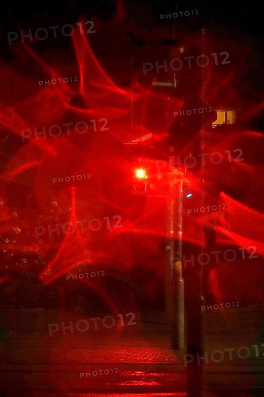 Traffic light, road traffic at night and poor visibility in a city, autumn, Germany