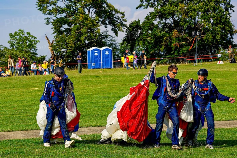 Parachutists have landed after an aerial acrobatic performance during an air show on the Rossfeld in Metzingen-Glems, Baden-Württemberg, Germany, for editorial use only