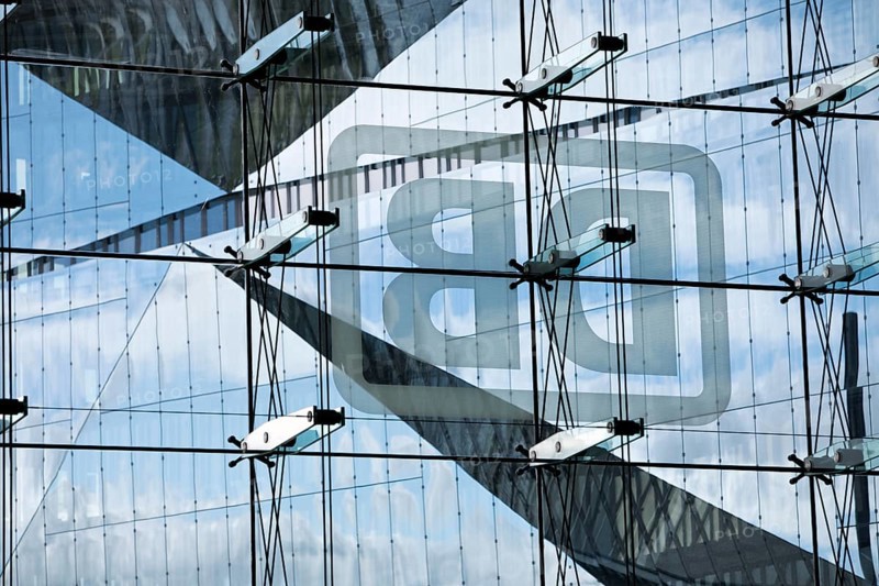 Cube Berlin seen through the glass facade of the main railway station with the mirror-inverted DB logo, Washingtonplatz, Berlin, Germany