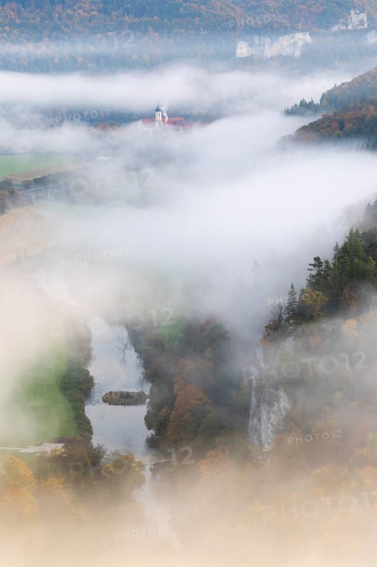 View of Benedictine monastery Beuron, Archabbey of St. Martin, Danube, river, limestone rock, rock face, mixed forest, autumn colours, fog, autumn, Fridingen, Danube valley, Upper Danube nature park Park, Baden-Württemberg, Germany
