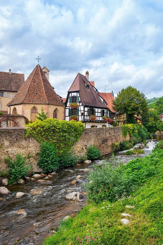 Picturesque Kaysersberg with half-timbered houses on the Weiss river in the old town centre