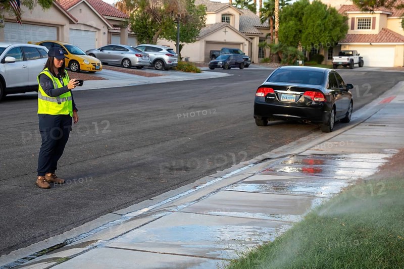 Las Vegas, Nevada - Devyn Choltko, a water waste investigator, patrols a residential neighborhood, recording and issuing tickets for illegal water use. The Las Vegas Valley Water District has cut usage of scarce Colorado River water by more than 30% over the last 20 years despite a growing population