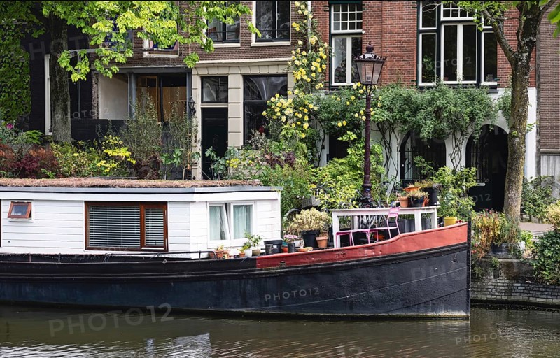 Holland, Amsterdam canals with boats, scenic bridges and historic city center, UNESCO World Heritage site