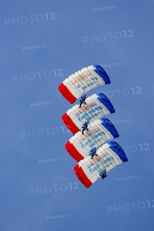 Parachutists during an aerial acrobatic demonstration as part of an air show on the Rossfeld in Metzingen-Glems, Baden-Württemberg, Germany, for editorial use only