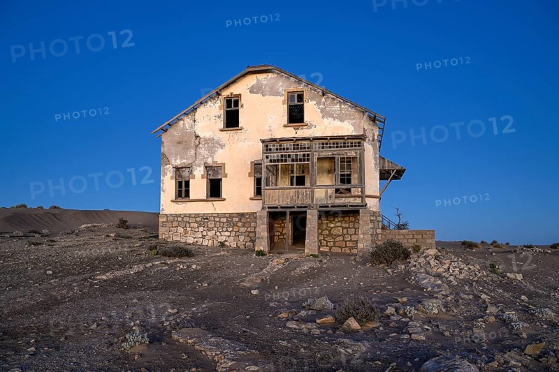 Dilapidated building in the desert sand, blue hour, Kolmanskop, near Lüderitz, Karas region, Namibia