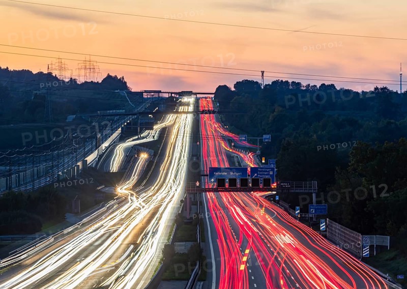 Motorway near Stuttgart with several lanes in the evening with sunset. Heavy traffic with light lanes. BAB 8 motorway near Wendlingen, Baden-Württemberg, Germany