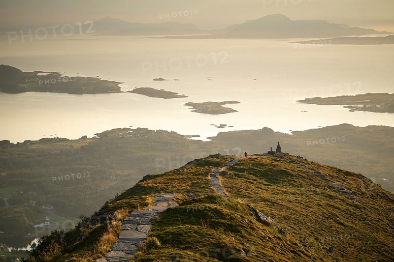 Cairns and view over islands and sea, evening mood, Rørsethornet stone staircase, with 3292 steps one of the longest continuous stone staircases in the world, Sherpat staircase or Midsund staircase or Midsundtrappene, Rørsethornet hike, Otroya or Otrøya island, Møre og Romsdal, Norway