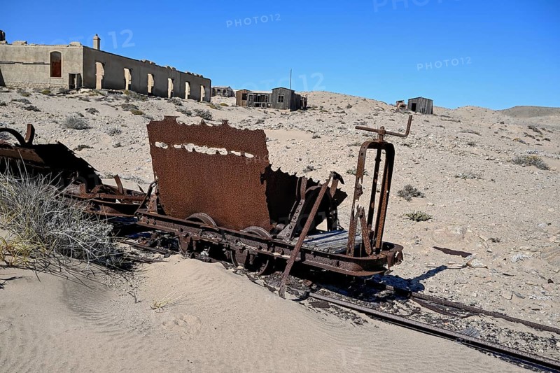 Wagon of an old narrow-gauge railway in the desert sand, Pomona, restricted diamond area, near Lüderitz, Karas region, Namibia