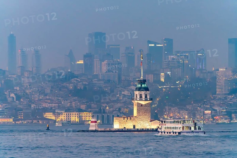 The Maiden Tower lighthouse, Leander Tower or Maiden Tower in front of the Istanbul skyline at dusk, Turkey