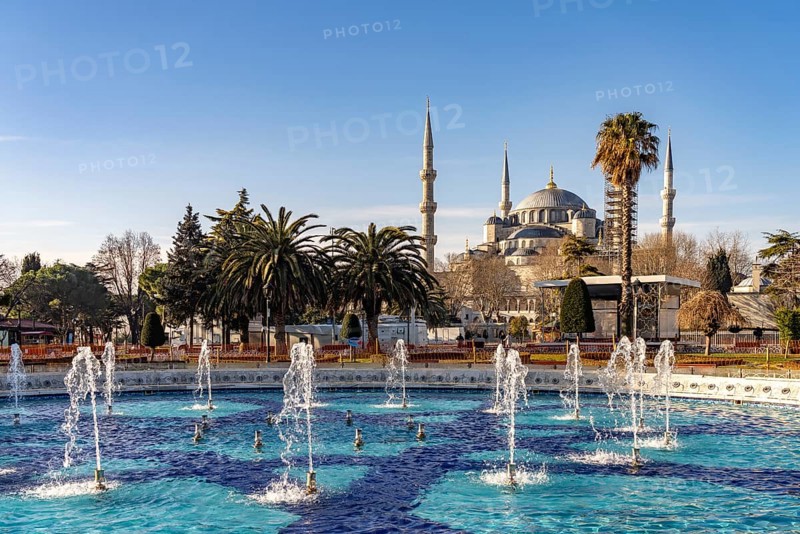 Fountain in Sultan Ahmet Park and the Blue Mosque or Sultan Ahmed Mosque in Istanbul, Turkey