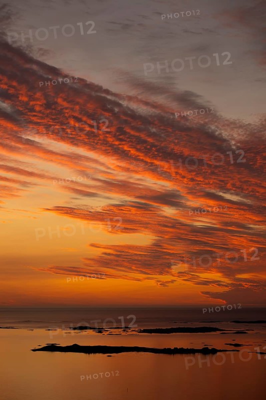 Offshore islands and skerries, sea, dramatically illuminated clouds, sunset, Otroya or Otrøya island, Møre og Romsdal, Norway