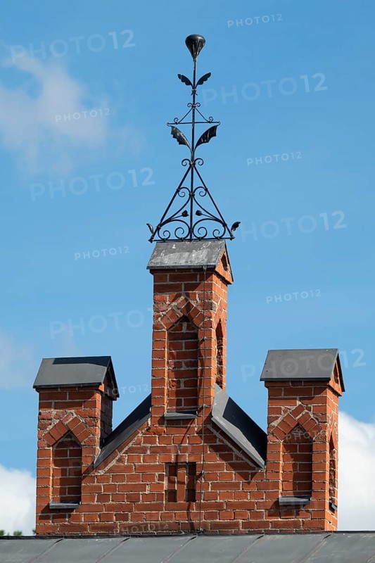 Iron ornamental element on roof peak, brick gable, former paper mill for the production of groundwood pulp board, UNESCO World Heritage Site Factory Village Verla, Maailmanperintökohde Verlan puuhiomo ja pahvitehdas, Verla Rapids, Kymenlaakso, near Kouvola, Finland