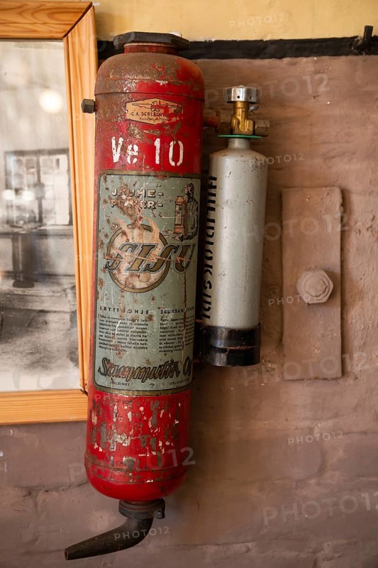 Old, rusty fire extinguisher from the Sisu company, former paper factory and mill for the production of groundwood pulp board, UNESCO World Heritage Site Factory Village Verla, Maailmanperintökohde Verlan puuhiomo ja pahvitehdas, Verla Rapids, Kymenlaakso, near Kouvola, Finland