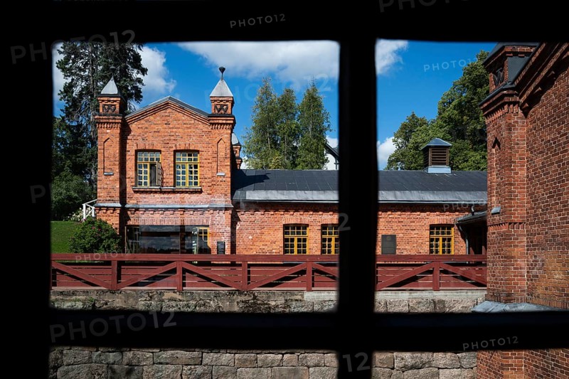 View through window frames, brick building, former paper factory and mill for the production of groundwood pulp board, UNESCO World Heritage Site Factory Village Verla, Maailmanperintökohde Verlan puuhiomo ja pahvitehdas, Verla Rapids, Kymenlaakso, near Kouvola, Finland