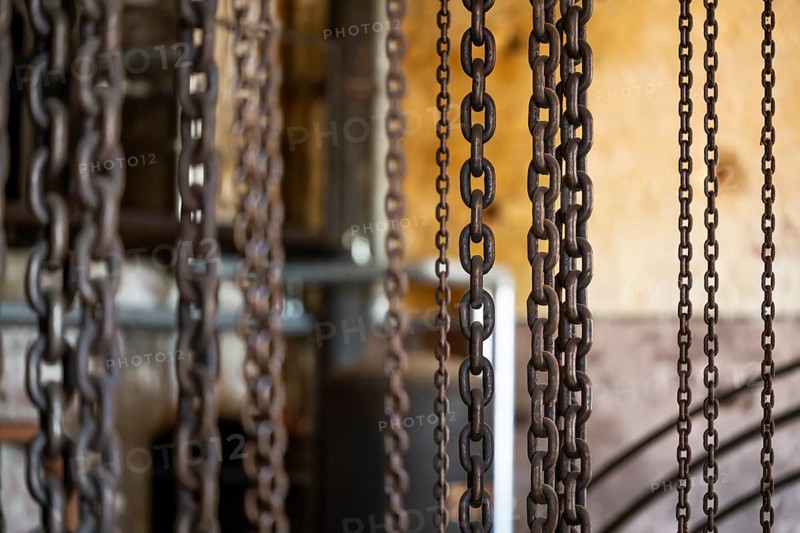 Hanging iron chains in various sizes, factory hall with machines for the production of cardboard and paper, former paper factory and mill for the production of groundwood pulp board, UNESCO World Heritage Site Verla Factory Village, Maailmanperintökohde Verlan puuhiomo ja pahvitehdas, Verla Rapids, Kymenlaakso, near Kouvola, Finland