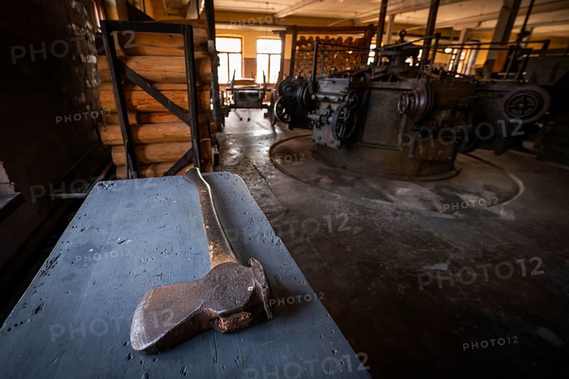 Hatchet on a table, factory hall with historical machines for the production of cardboard and paper, former paper factory and mill for the production of groundwood pulp board, UNESCO World Heritage Site Verla Factory Village, Maailmanperintökohde Verlan puuhiomo ja pahvitehdas, Verla Rapids, Kymenlaakso, near Kouvola, Finland