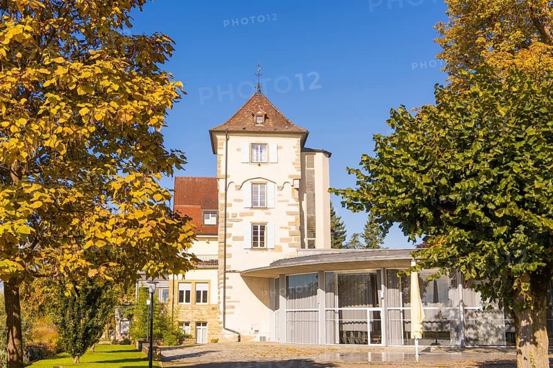 Historic building with tower and autumnal trees under a blue sky, Überlingen, Lake Constance, Germany