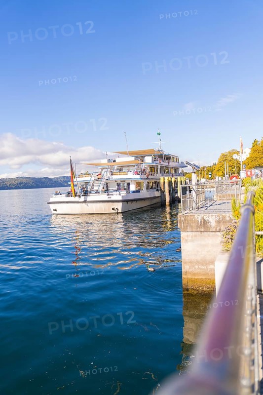 Ship in the harbour under a clear sky on calm water, Überlingen, Lake Constance, Germany