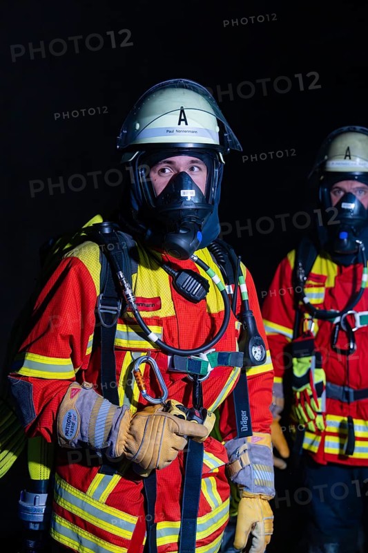 Firefighter with breathing apparatus in the dark, concentrated and ready for action, firefighting exercise in the new construction tunnel of the Hermann Hesse railway, Ostelsheim, Calw district, Germany