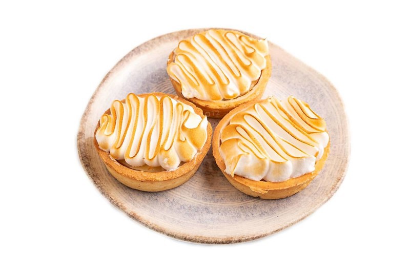 French lemon tart with meringue isolated on white background, side view, close up