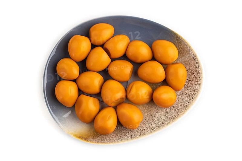 Pile of Smoked Quail eggs isolated on white background. top view, flat lay, close up