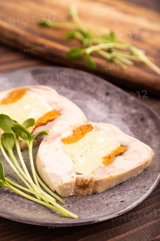 Chicken, egg and dried apricot meatloaf, microgreen on brown wooden. Diet, healthy eating. side view, selective focus