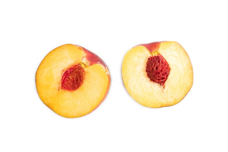 Peach Cut in half isolated on white background. Top view, flat lay, close up. healthy food, vegetable, minimalism