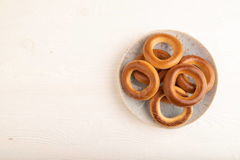 Homemade Ring Bagel on white wooden background. top view, flat lay, copy space