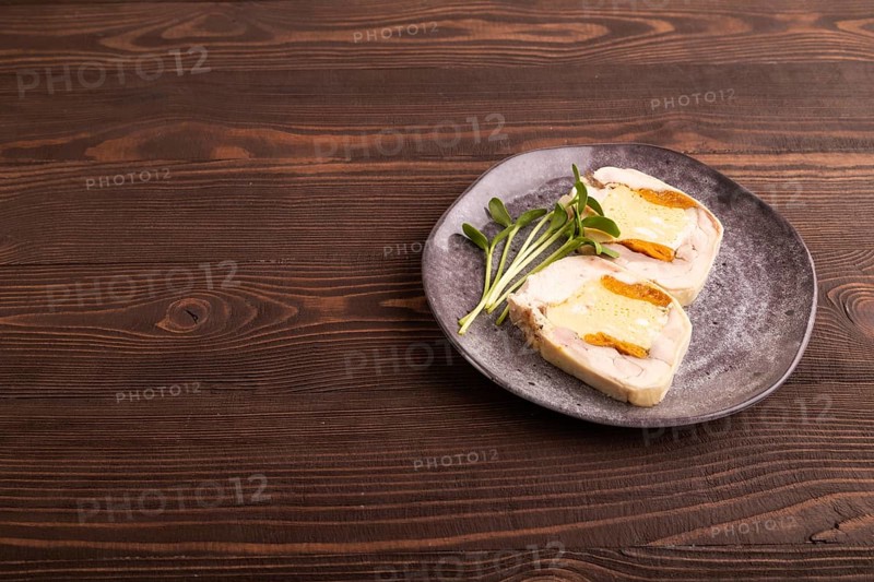 Chicken, egg and dried apricot meatloaf, microgreen on brown wooden. Diet, healthy eating. side view, copy space