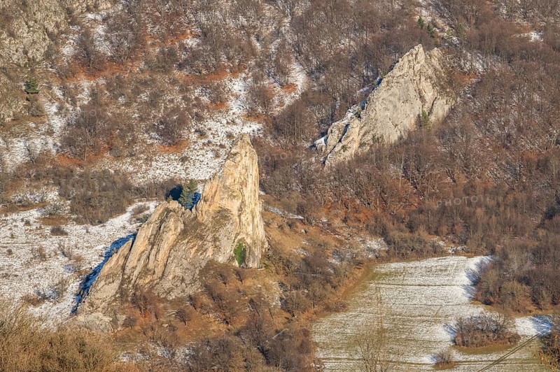 Cervenokamenské cliff (cervenokamenske bradlo), a huge rock at a mountain with bushes, trees and meadows in winter, Vápec, Horná Poruba, Slovakia
