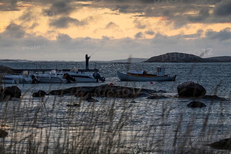 Small bay, archipelago, jetty with angler, Resö Island, Bohuslän, Skagerrak, Sotenäs, Västra Götalands län, Sweden