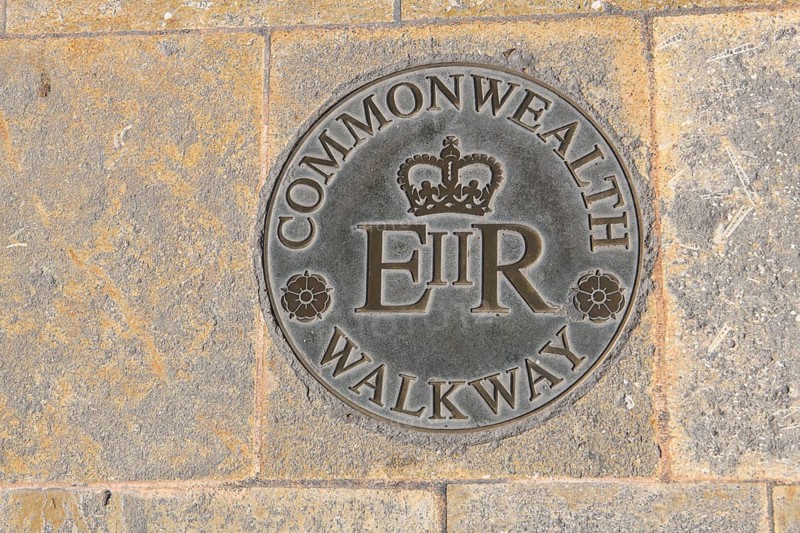 Large round plaque in plate from pedestrian zone in Valletta capital of Malta floor plaque with inscription Commonwealth Walkway and stylised British crown below E II R for Ween Elizabeth II Regina English Queen Elizabeth II, Valletta, Malta
