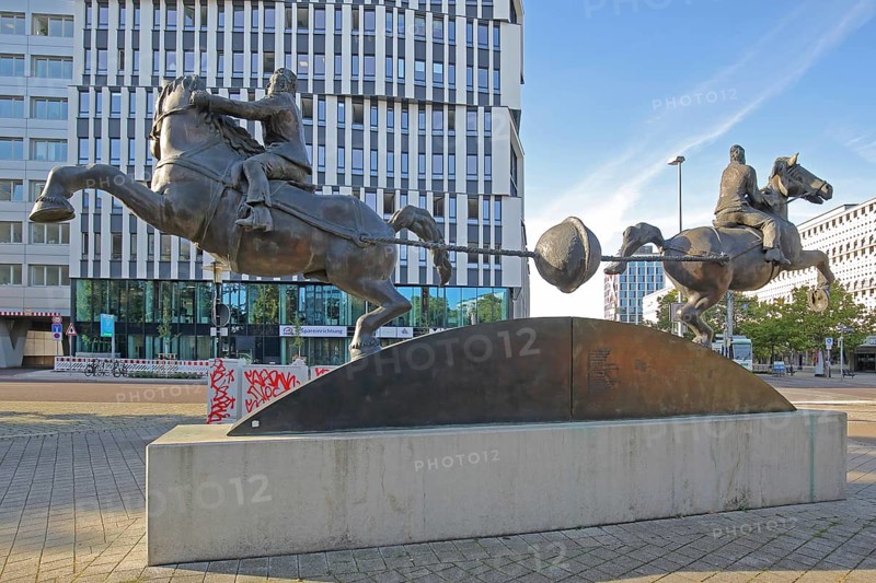 Magdeburg hemispheres by Thomas Virnich 2012, monument to physicist and mathematician Otto von Guericke, two equestrian figures pull apart halved sphere, inventor, negative pressure, vacuum, symbol, power, strength, separate, struts, inside, landmark, Ratswappenplatz, Magdeburg, Saxony-Anhalt, Germany