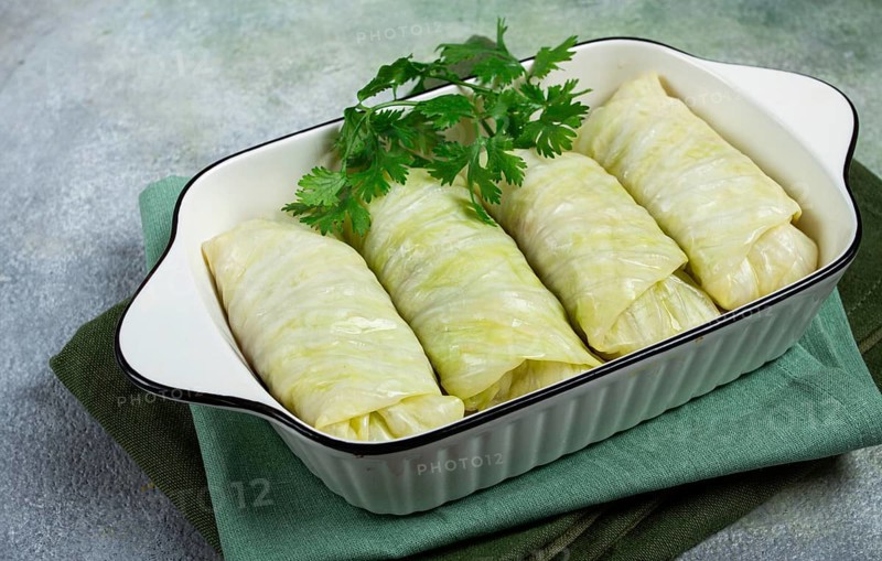 Raw cabbage rolls, not cooked, with minced meat, top view, without people, in the spotlight