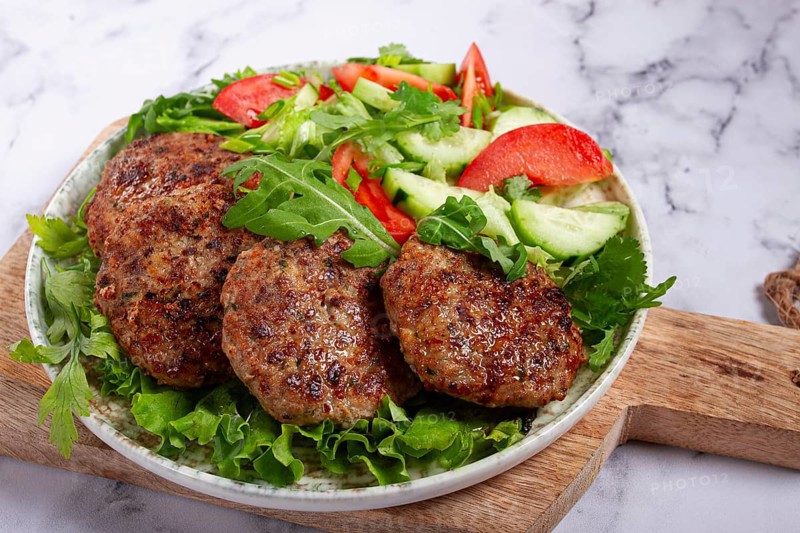 Fried cutlets, mixed minced meat, with vegetable salad, homemade, top view, no people