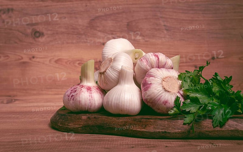 Fresh young garlic, white and purple color, on a wooden table, no people