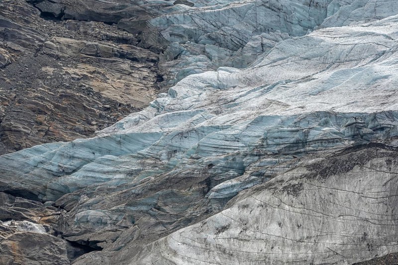 Majestic ice formations dominate the rocky terrain and show the beauty of a glacier in a secluded mountain location in daylight. The inseparable textures emphasise the artistry of nature. Gorner Glacier, Zermatt, Valais, Alps, Swiss