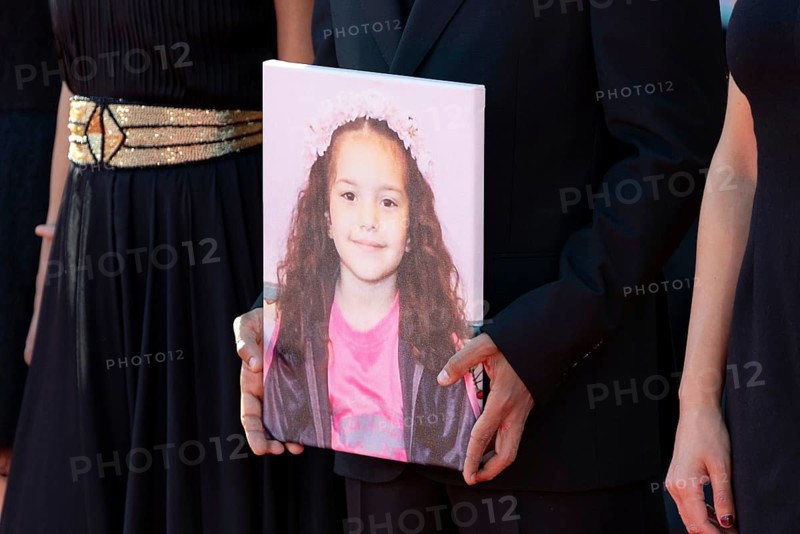 Venice, Italy - 3 September 2025: Motaz Malhees with a portrait of five-year-old Palestinian girl Hind Rajab, who was killed by the Israeli army in the Gaza Strip in January 2024, during the red carpet of - The Voice Of Hind Rajab - during the 82nd Venice International Film Festival