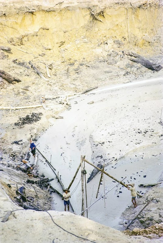 Open Cast gravel-pumping tin mine Malaya, Malaysia, south east Asia 1964 - high pressure water cannon jet spray to wash out sediment into a slurry
