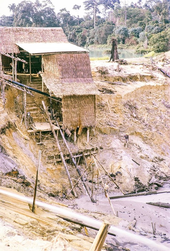 Open Cast gravel-pumping tin mine Malaya, Malaysia, south east Asia 1964 - pumping raises the slurry from the sump to an elevated wooden sluice level called a palong