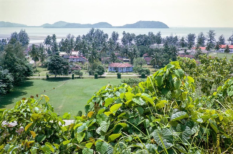 View to offshore island over houses in coastal area near Mersing, Johor, Malaya, Malaysia, south east Asia 1964