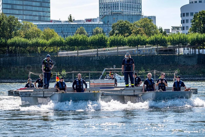 Exercise run of a multi-purpose pontoon on the Rhine, Medienhafen, of the Water Hazards Section, in Düsseldorf, the motorised pontoon can be used as a ferry for people or equipment, as a working platform or bridge, during the major exercise FÜLEX25, lasting several days, of the THW, Technisches Hilfswerk, Landesverband North Rhine-Westphalia, on 4 weekends over 3500 volunteers from the 127 North Rhine-Westphalia local associations practise many different deployment scenarios