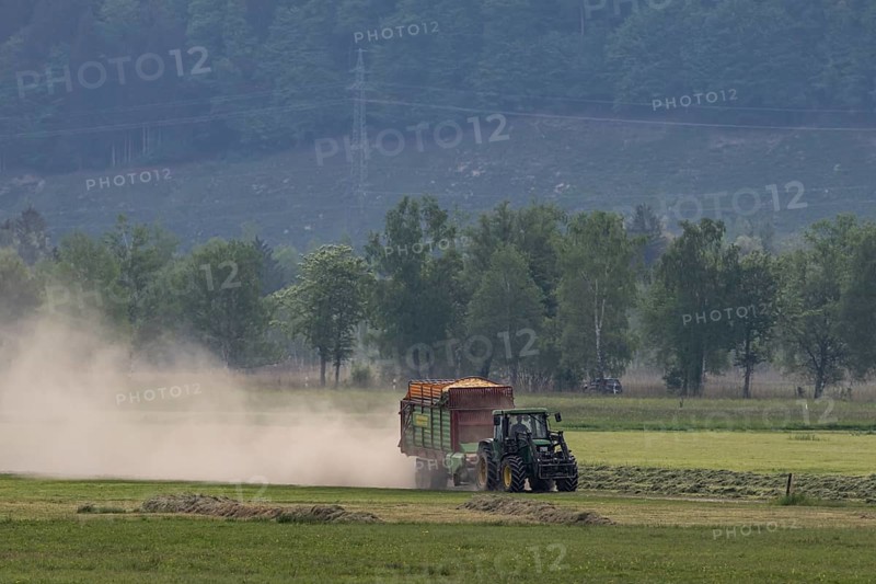 Tractor driving with trailer, mowing grass, meadow, dust, drought, summer, Alpine foothills, Bad-Tölz district, Bavaria, Germany