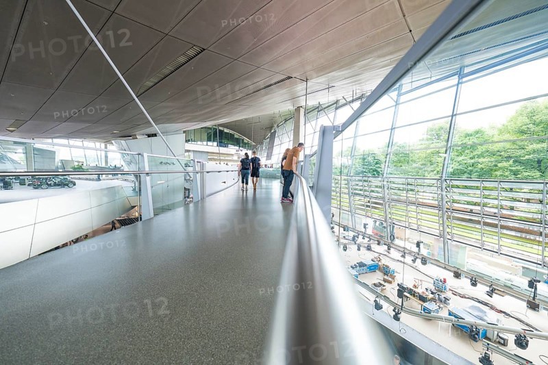 Glass balcony in a modern space with people enjoying the view, BMW Welt, Munich, Germany