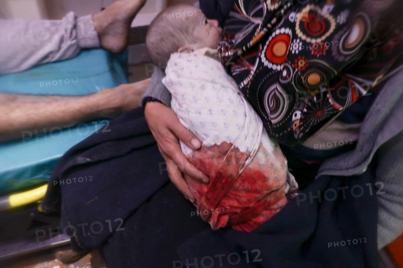 A frightened mother carries her infant after he was pulled from the rubble of a deadly earthquake that struck Turkey and Syria, leaving tens of thousands dead. Aleppo, Syria – Feb 6, 2023, aleppo, syria