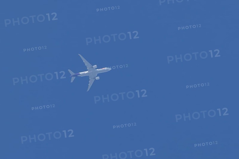Airbus A300-600RF jet aircraft of FedEx Express airlines in flight in a blue sky, England, United Kingdom