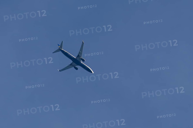 Boeing 737 jet passenger aircraft of Ryanair airlines flying in a blue sky, England, United Kingdom