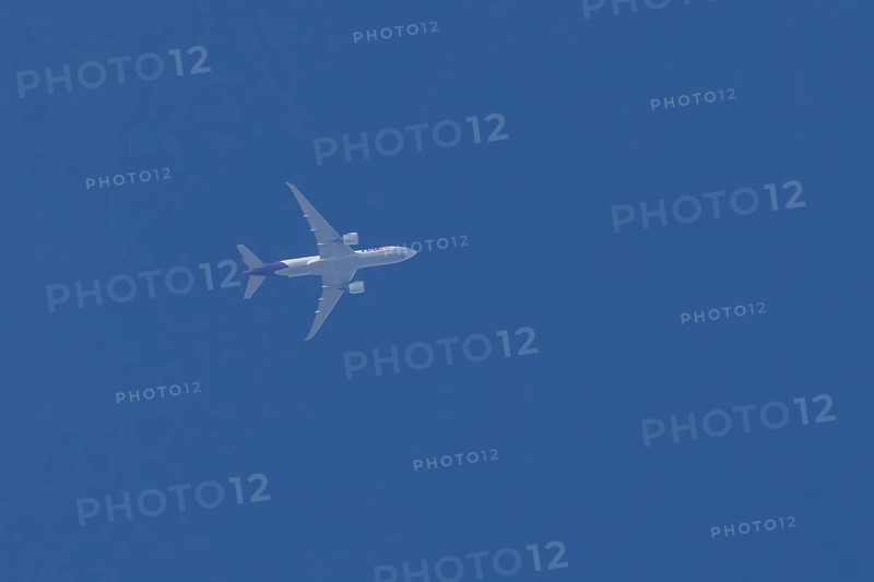 Airbus A300-600RF jet aircraft of FedEx Express airlines in flight in a blue sky, England, United Kingdom