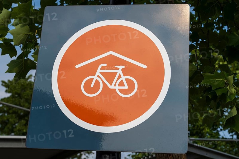 Covered bicycle parking space, sign with logo, Rheda-Wiedenbrück, Westphalia, North Rhine-Westphalia, Germany